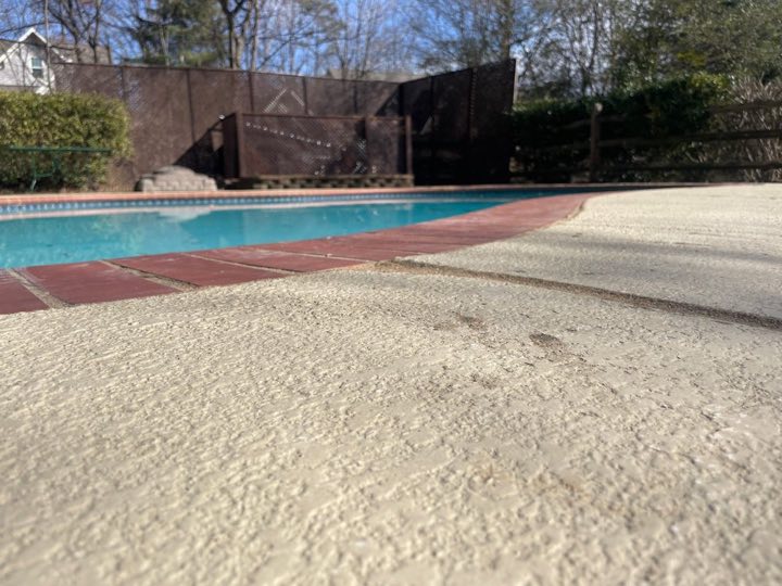 Pool deck lifted flush against the coping after foam injection