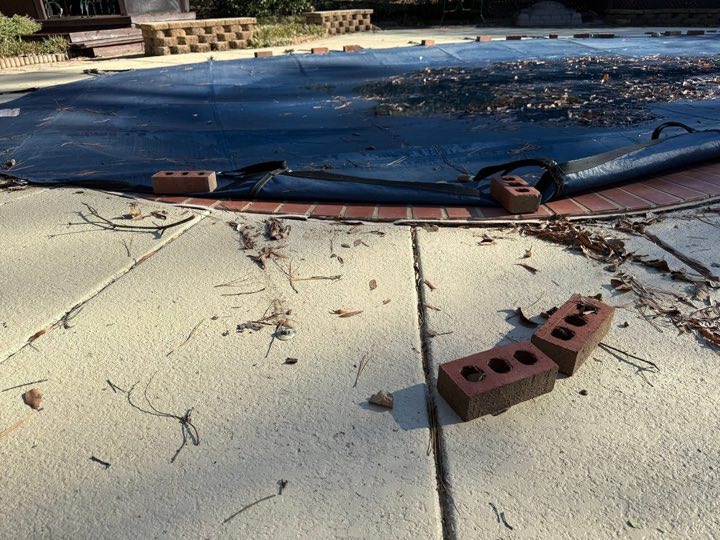 Settled pool deck marked for work before lifting