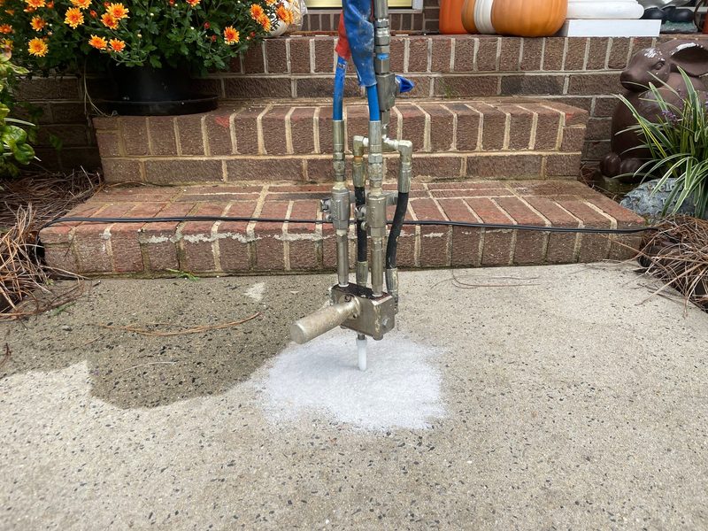 Polyurethane foam injection leveling sunken concrete beside steps in Houston